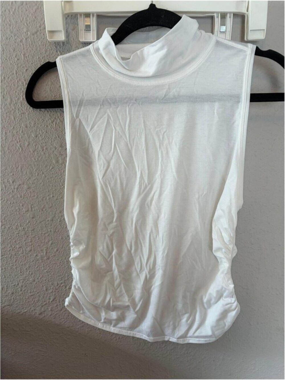 Lululemon white turtle neck ruched tank. Best for a 4. Armpits are discolored.